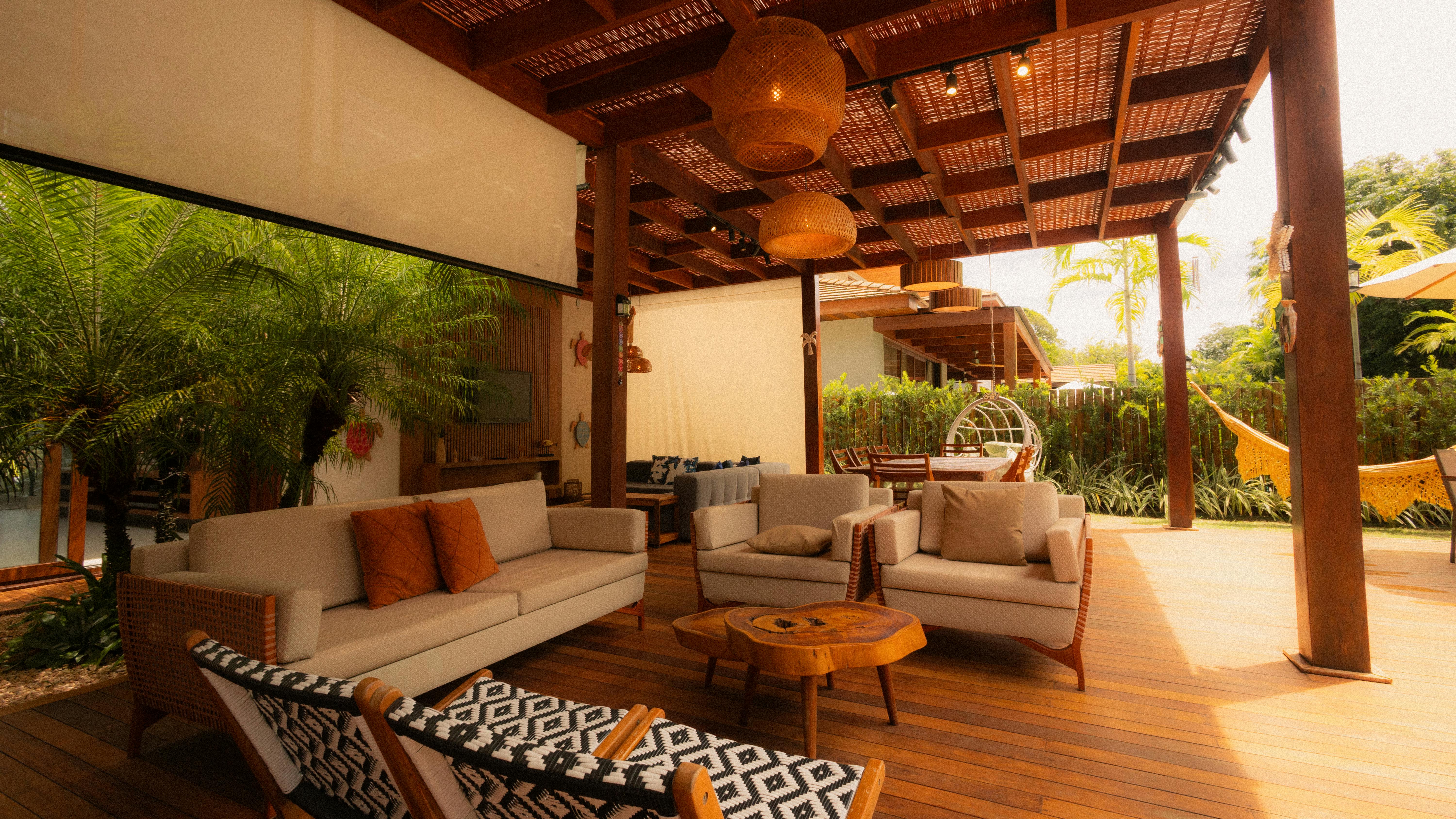 Cozy outdoor seating area with modern furniture set under a stylish wooden pergola perfect for relaxation.