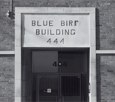 Entrance of Blue Bird Building 444, bridal boutique specializing in wedding dresses and bridal collections.