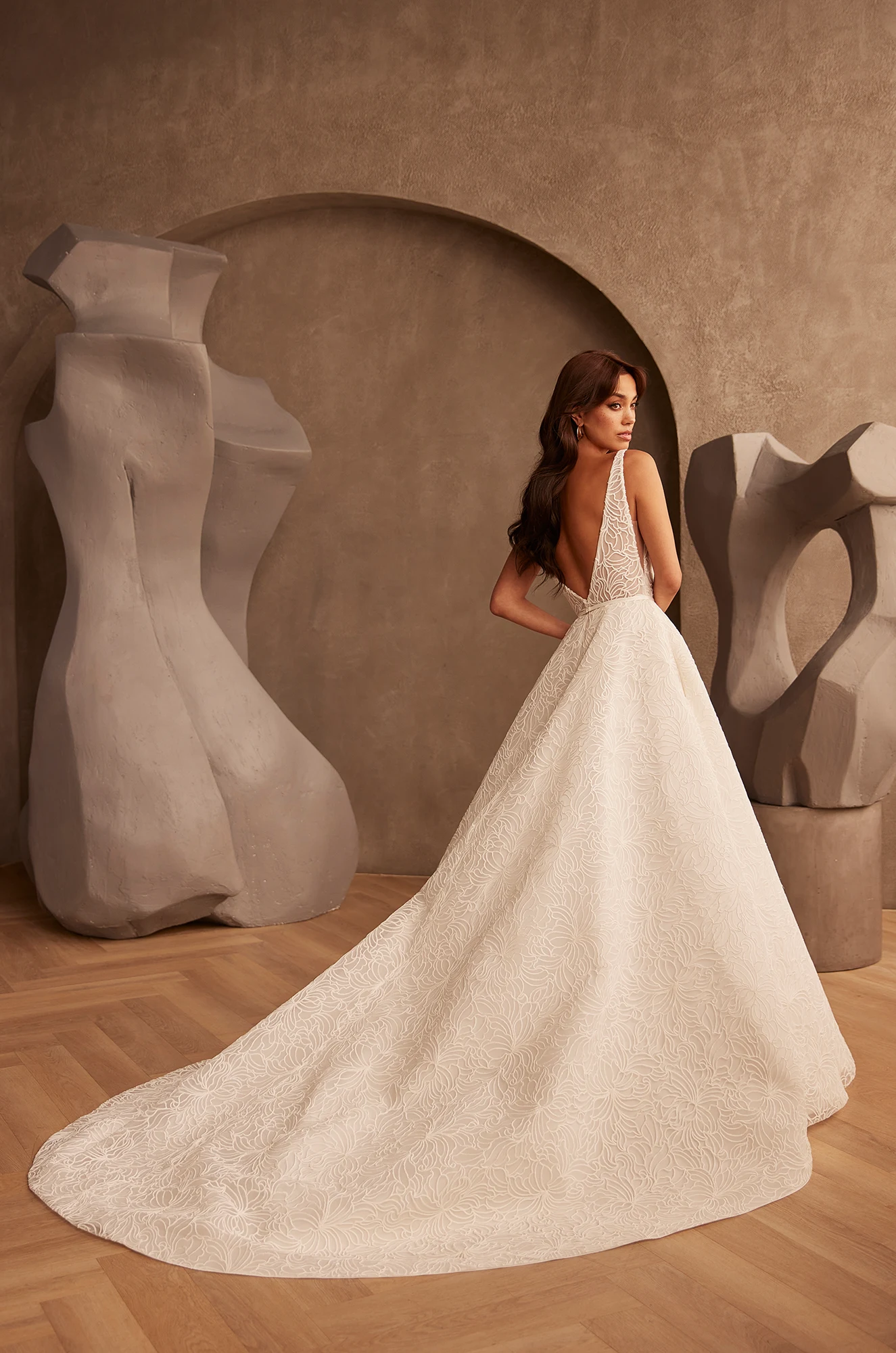 Wedding dress back view showing V-neckline and voluminous tulle ball gown silhouette.