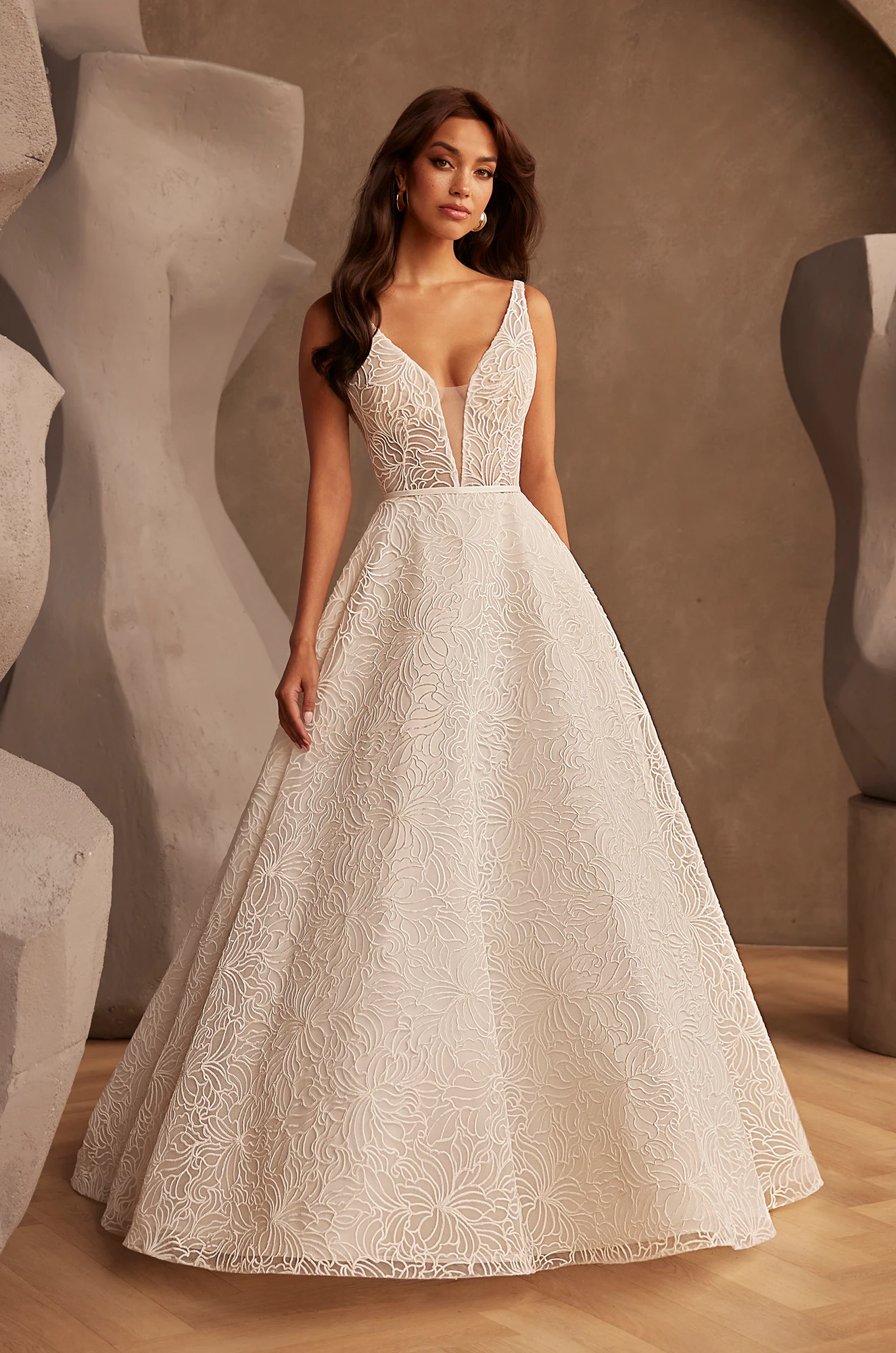 Front view of V-neckline tulle wedding dress with deep plunge, fitted bodice and flowing ball gown.