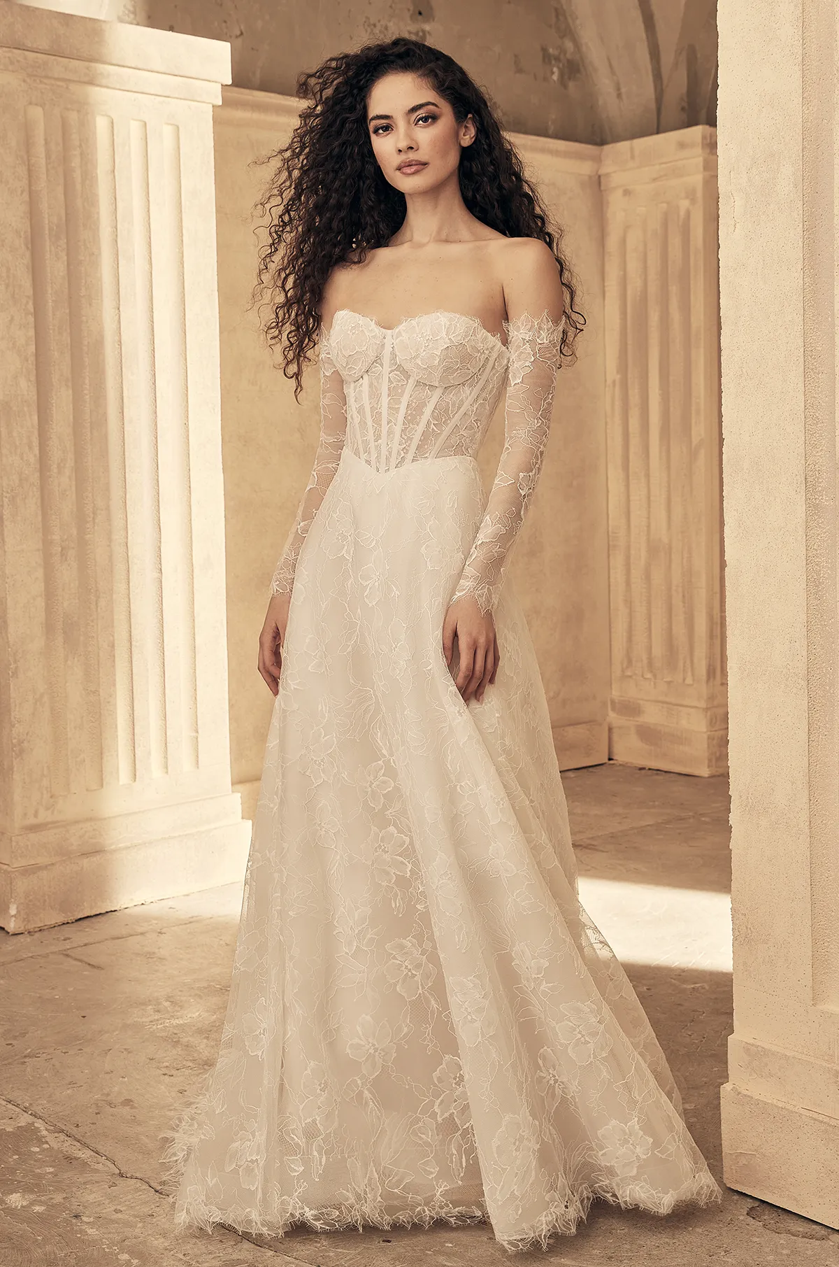 Off-shoulder lace wedding dress with long sleeves, corset bodice, and A-line skirt, ivory lace.