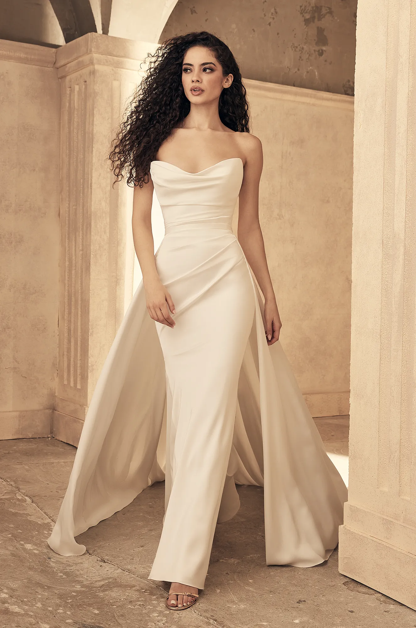 Ivory strapless cowl neck wedding dress with ruching and sweep train mermaid silhouette.