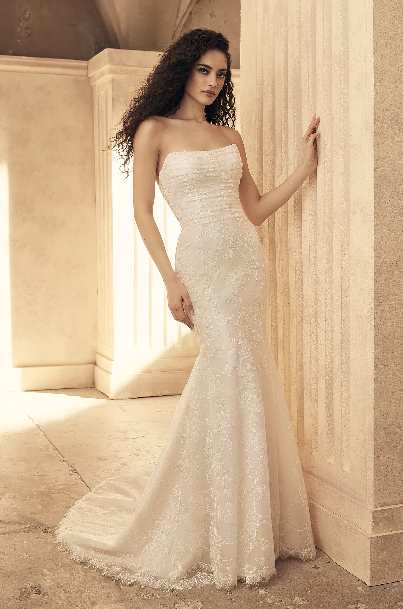 Front view of strapless lace wedding dress with ruched bodice, fitted mermaid silhouette and sweep train.