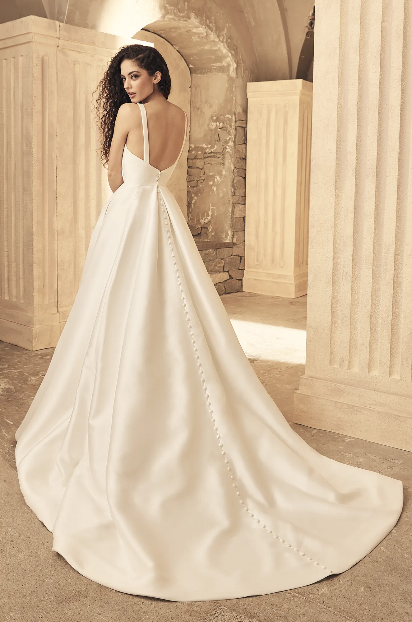 Mikado wedding dress back view showing square neckline and flowing mermaid silhouette train.