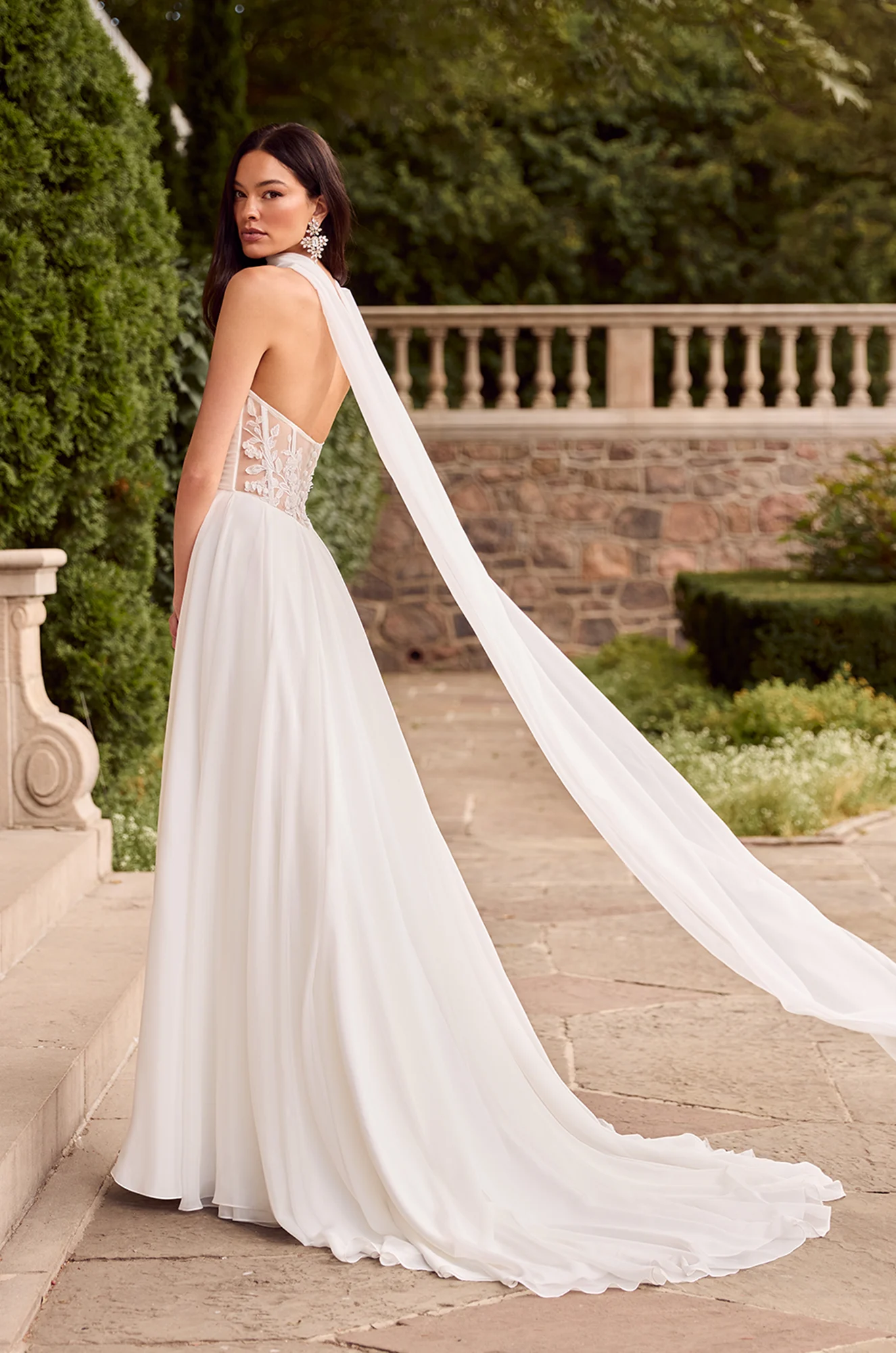 Wedding dress back view showing strapless design and flowing A-line silhouette with train.