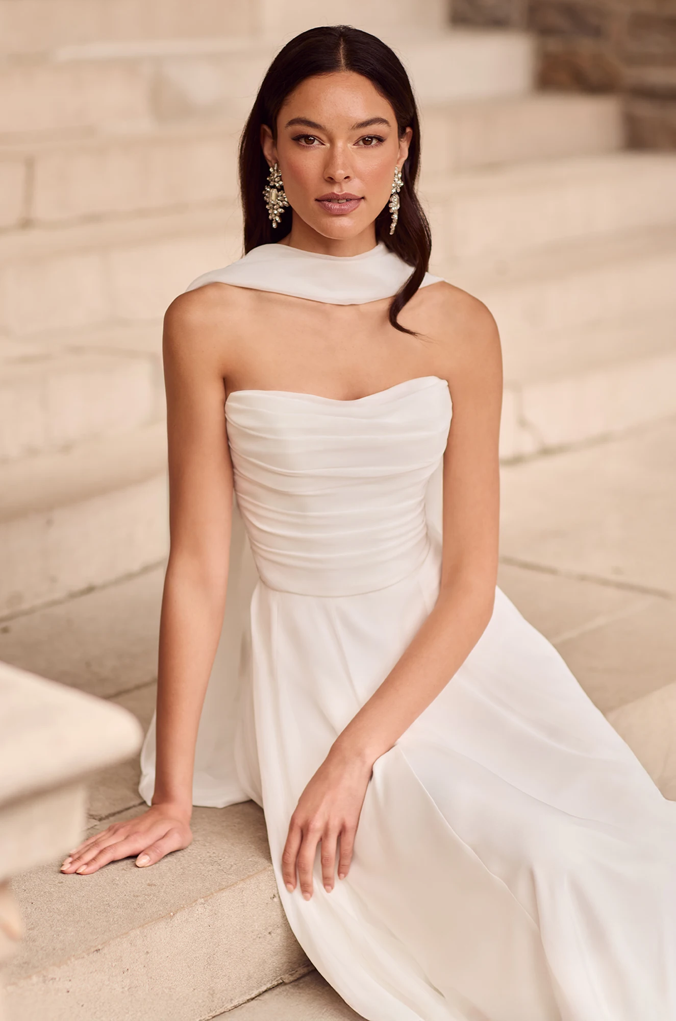 Wedding dress close-up showing ruched bodice detail and choker neckline design.
