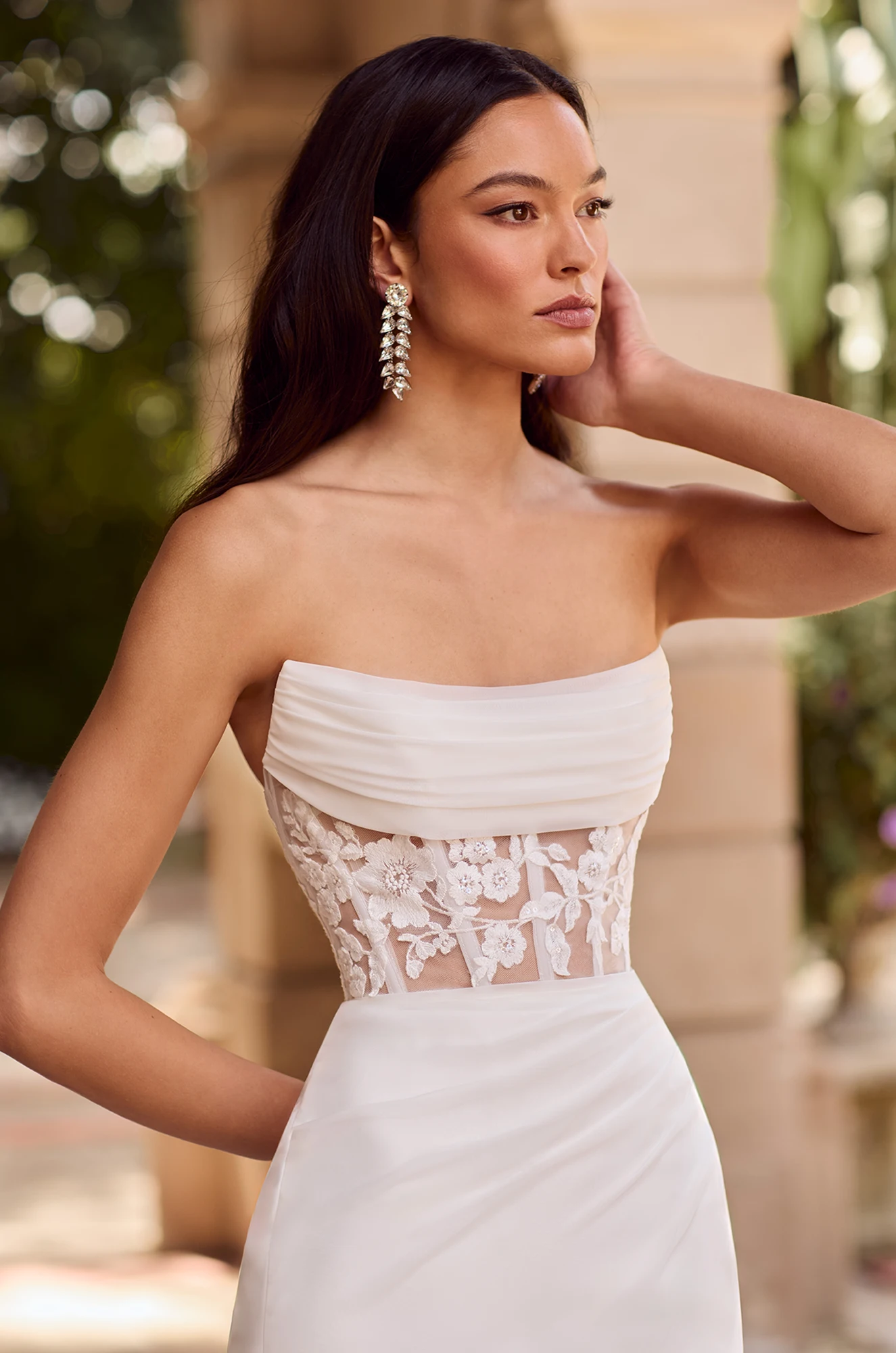 Wedding dress close-up showing no strap design and detailed lace corset bodice.