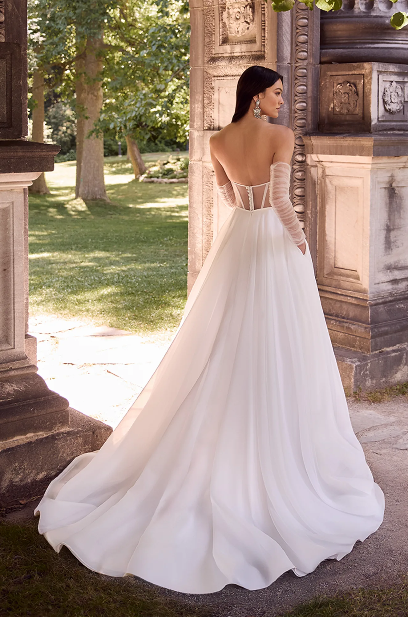 Wedding dress back view showing sweetheart neckline and flowing tulle ball gown silhouette.