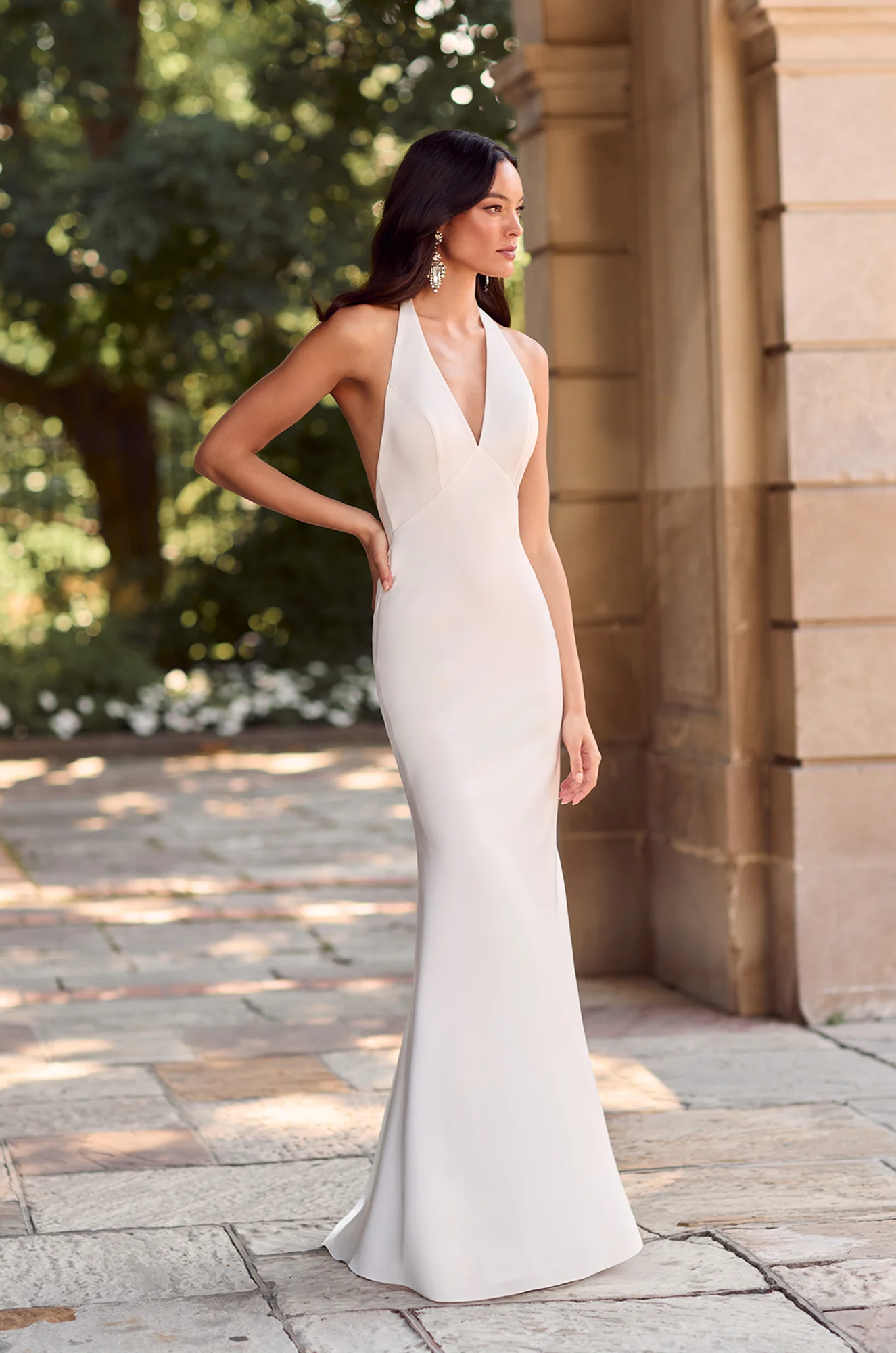 Front view of V-neckline satin wedding dress with fitted bodice and mermaid silhouette.