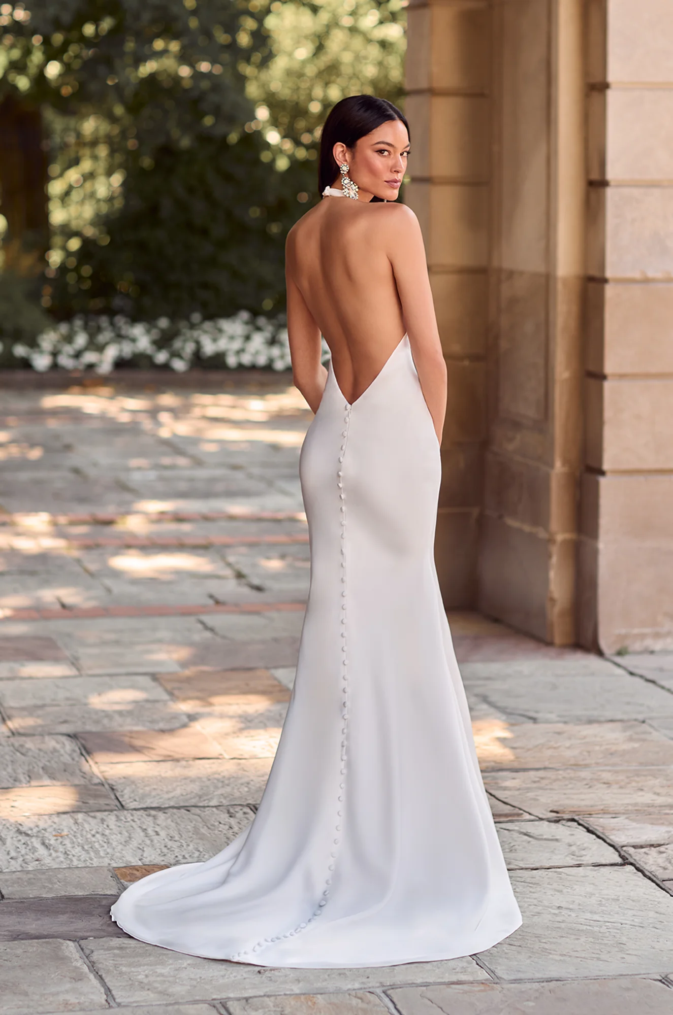 Wedding dress back view showing V-neckline and mermaid train.