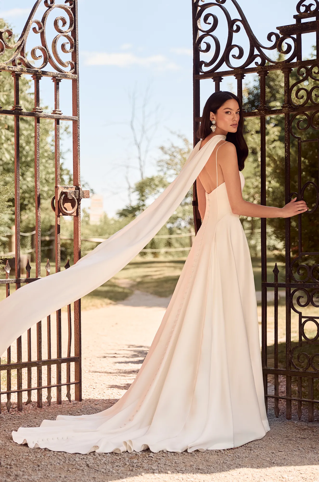 Wedding dress back view showing strapless design and elegant A-line silhouette with train.