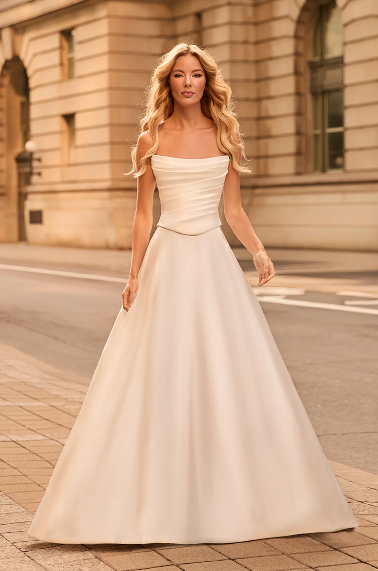 Classic satin A-line gown with draped scoop neckline, fitted bodice, and smooth full skirt for a sleek modern bridal look.
