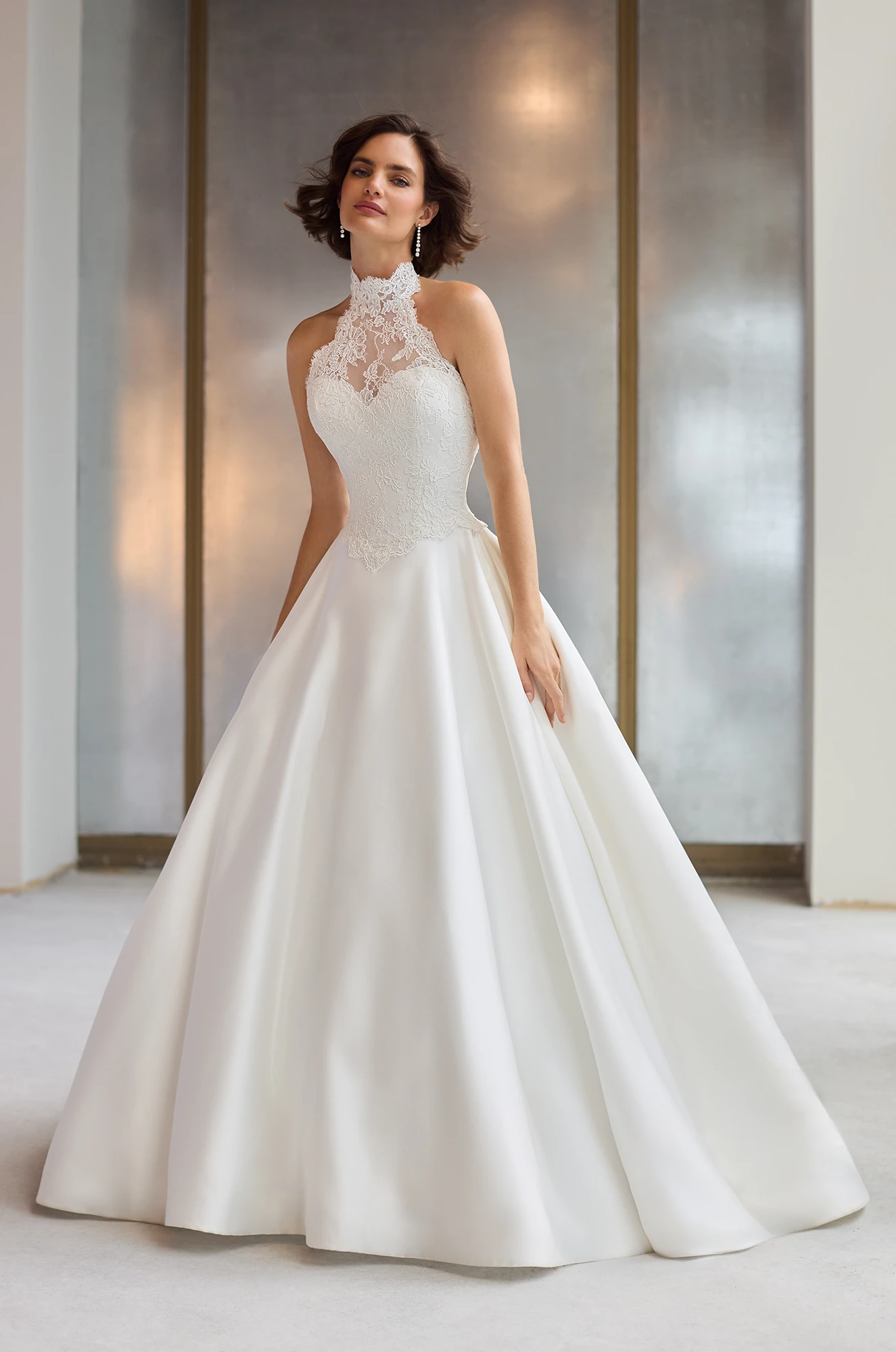 Halter neckline gown with Lace bodice and a satin A-line skirt with pockets.