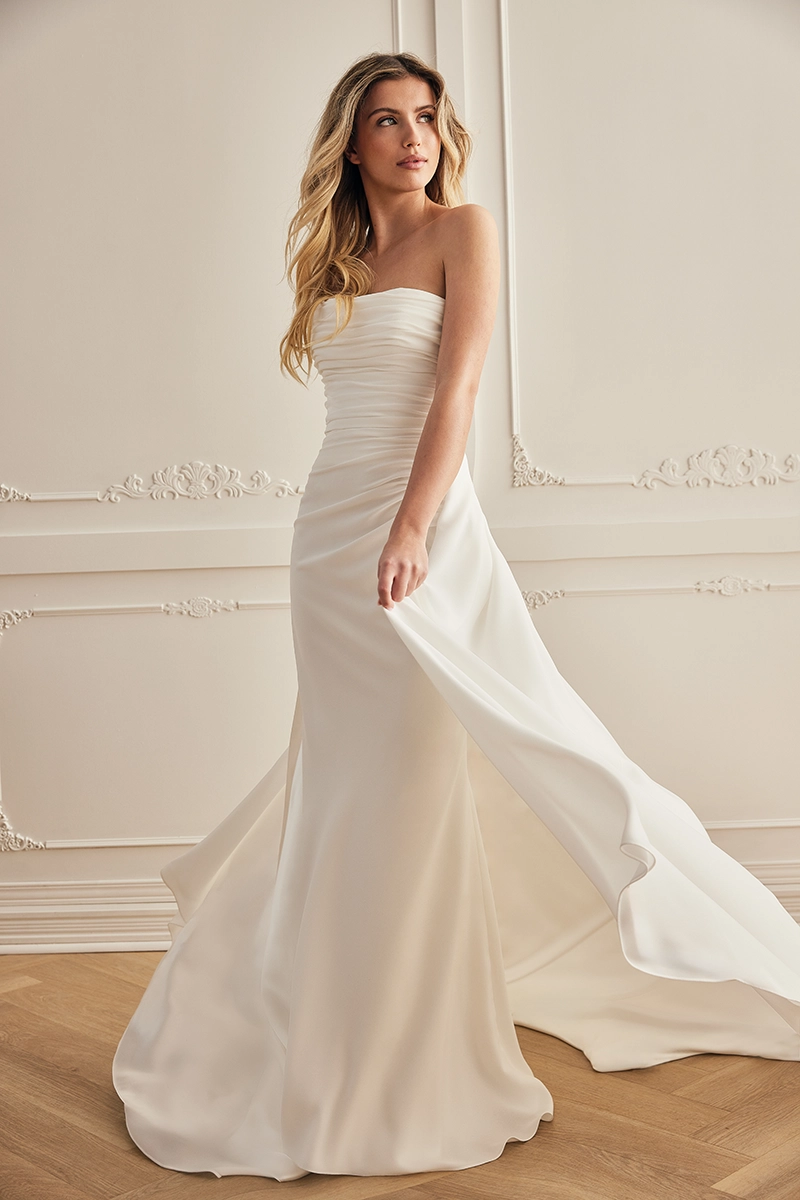Strapless wedding dress with a ruched bodice, soft draping, fit and flare skirt and flowing train in crepe.