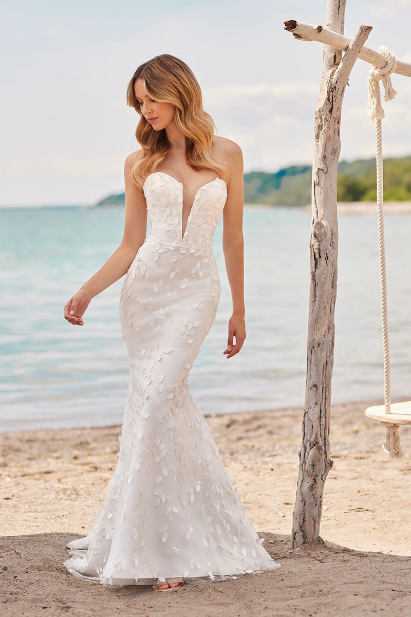 Strapless lace wedding dress with a deep plunge neckline, 3D leaf appliqué detailing, and fit and flare silhouette.