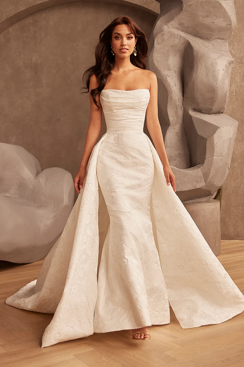 Strapless mermaid wedding dress with detachable overskirt, floral Brocade fabric and cathedral train.