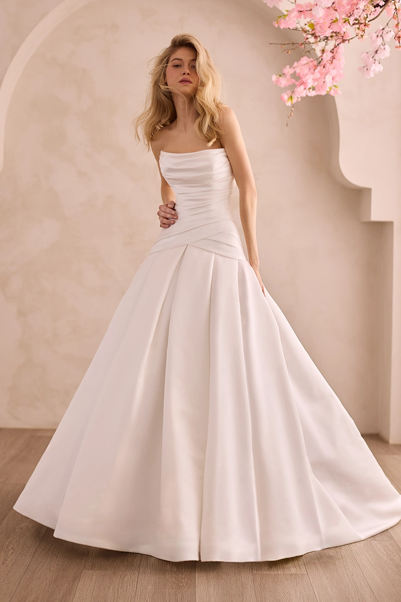 Strapless Satin gown with pleated drop waisted bodice and scoop neckline, with a box pleated skirt.