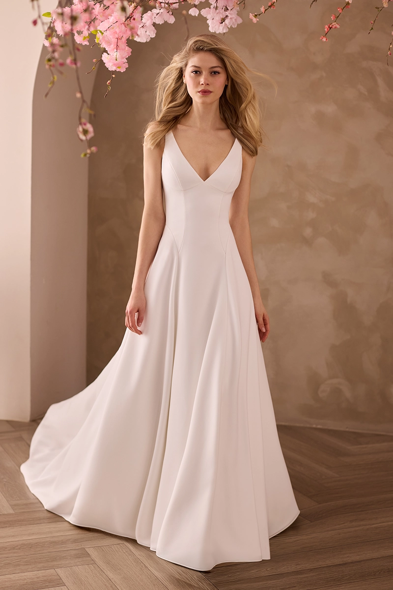 Crepe V-neckline gown with princess seams and side godets on an A-line skirt with pockets.