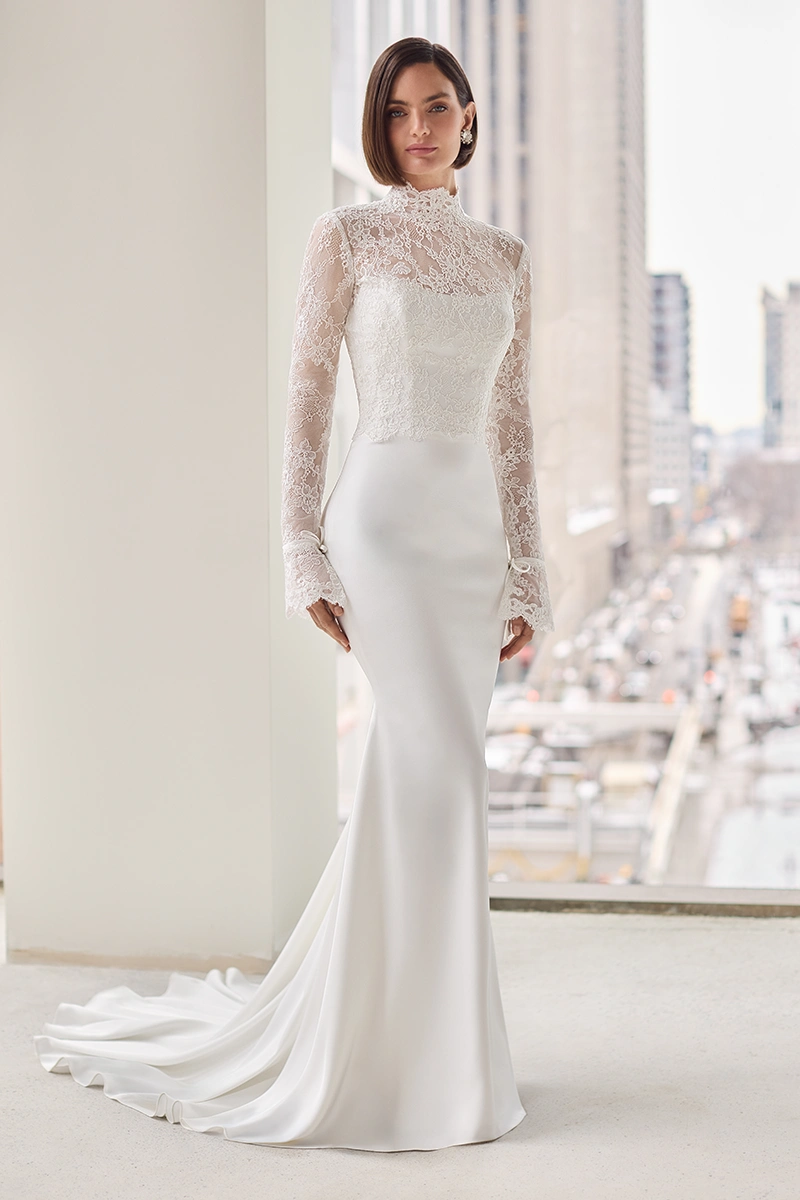 Charmeuse gown with a scoop neckline and fit and flare skirt, with a removable long sleeve lace topper.