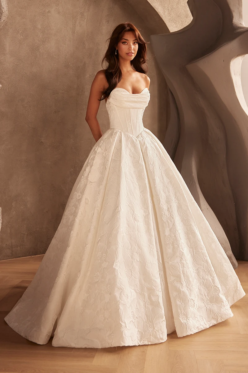 Ivory strapless Brocade wedding dress with corset bodice and floral full ball gown skirt.