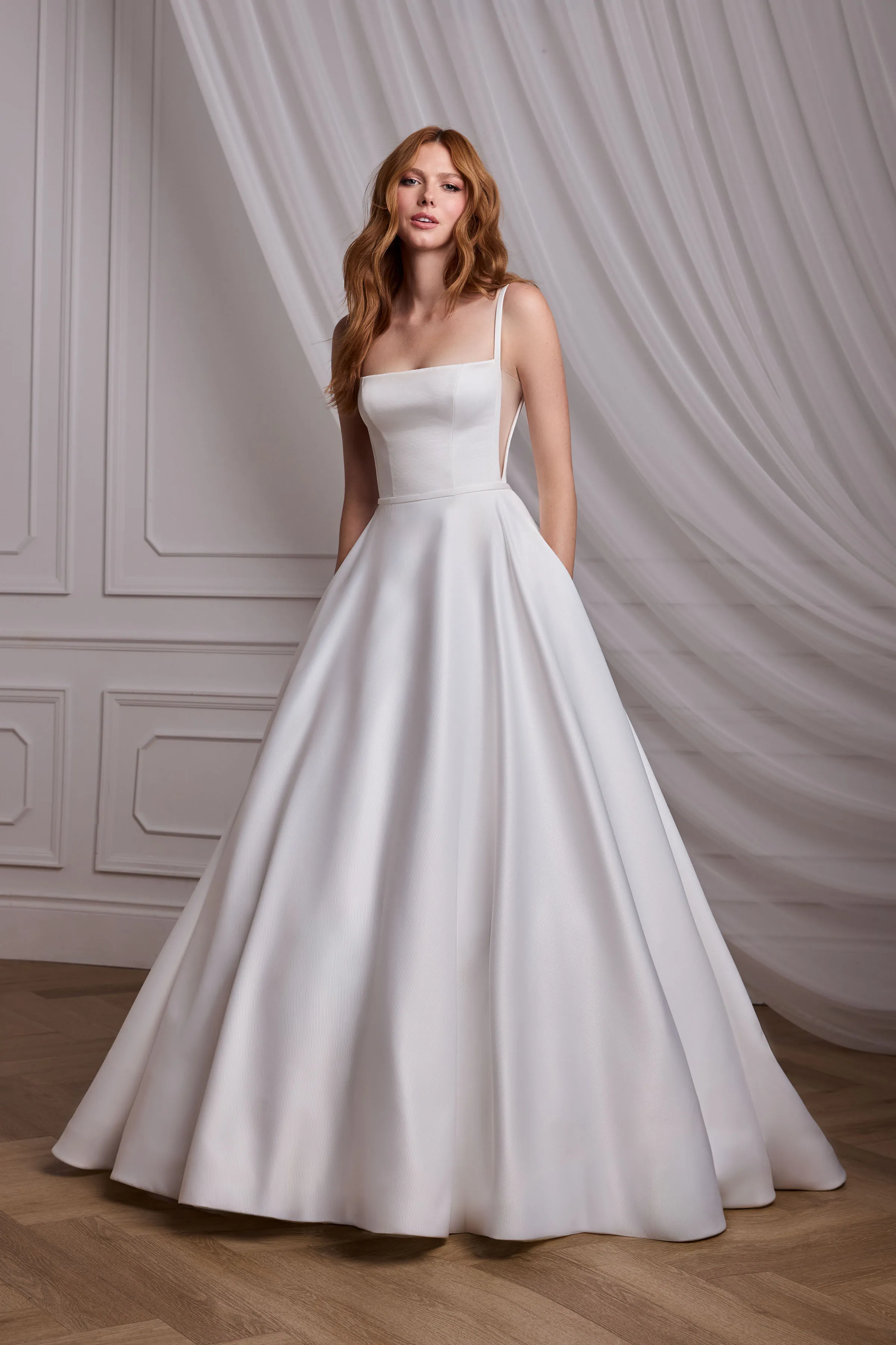 Sleeveless Satin Faille gown with a square neckline and tulle inserts on the side of the bodice, with a full circle skirt.