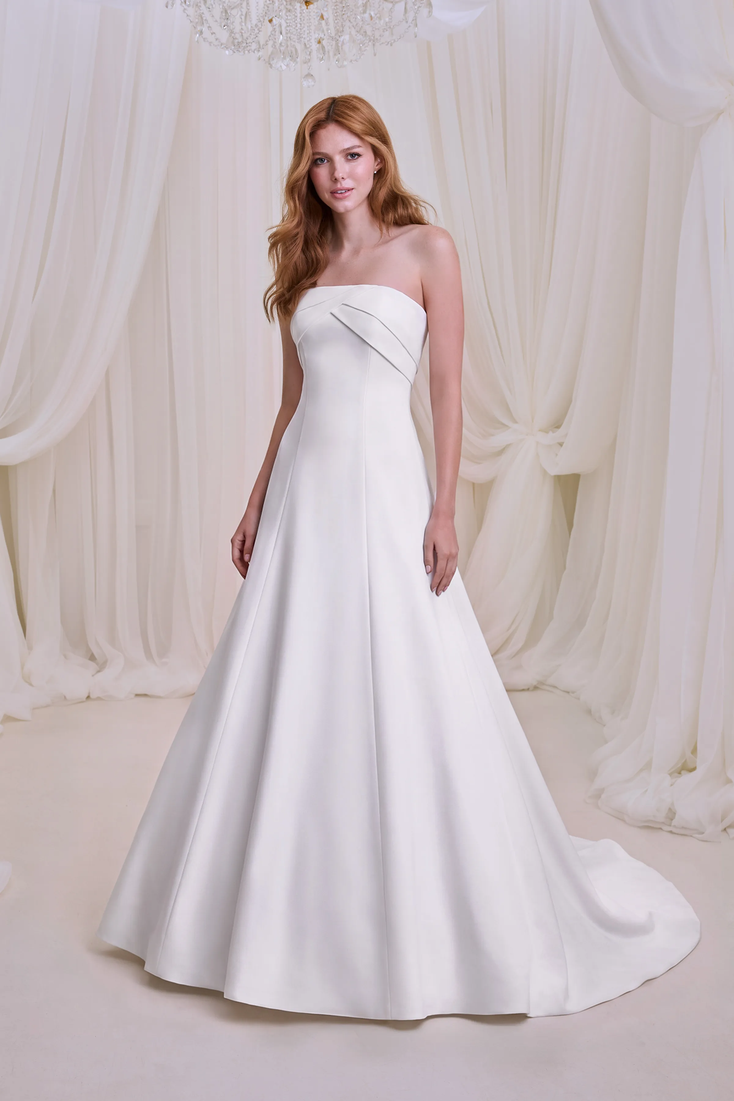 Strapless Satin princess seam gown with a crossover neckline drape and a modified A-line flared skirt.
