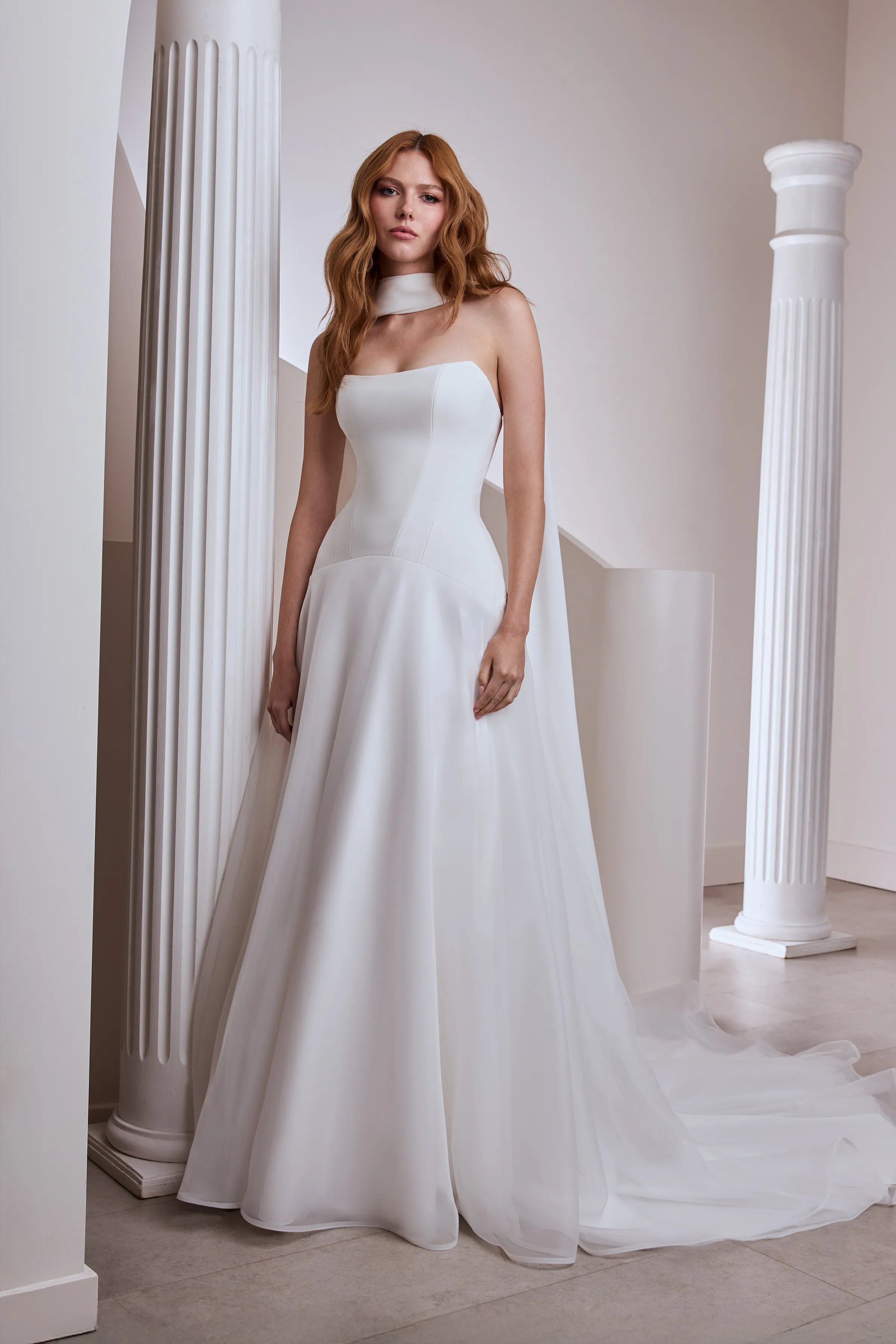 Strapless drop waisted gown with Crêpe scooped cat-eye neckline bodice, Crêpe scarf, and full Organza circle skirt.