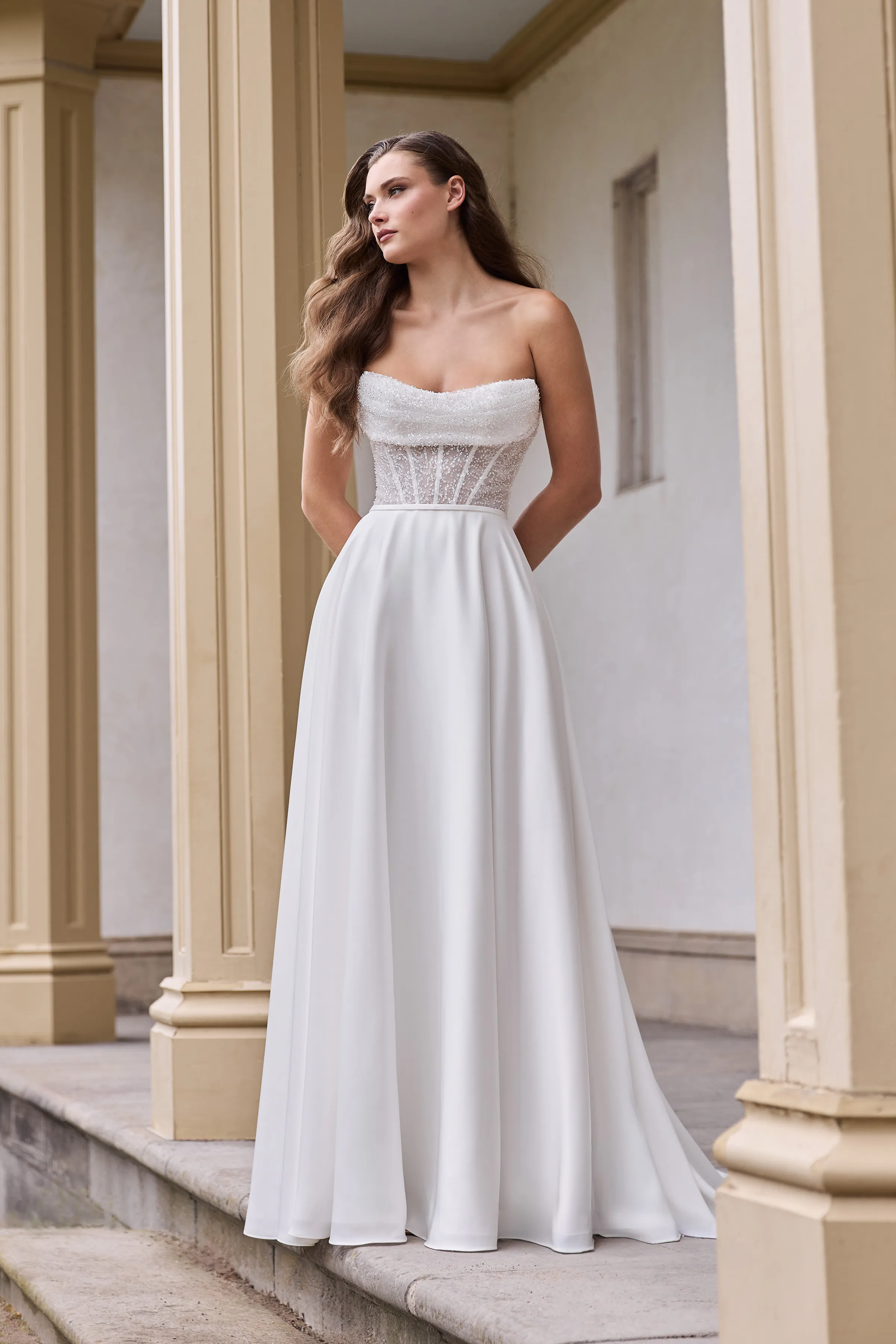 Strapless gown with a Beaded Tulle corset bodice with a draped scoop neckline, and an A-line Charmeuse skirt.