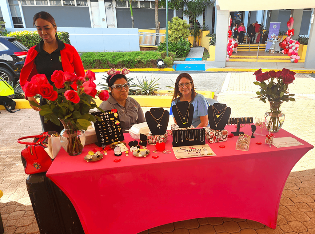 Women at their table with the jewelry they have for sale.