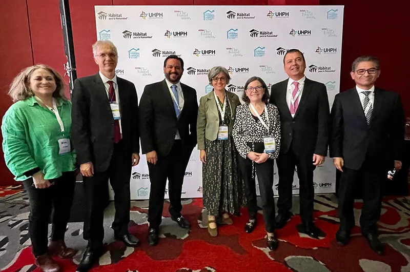 Secretario del Departamento de la Vivienda William Rodríguez junto a 6 personas en el foro en Colombia.