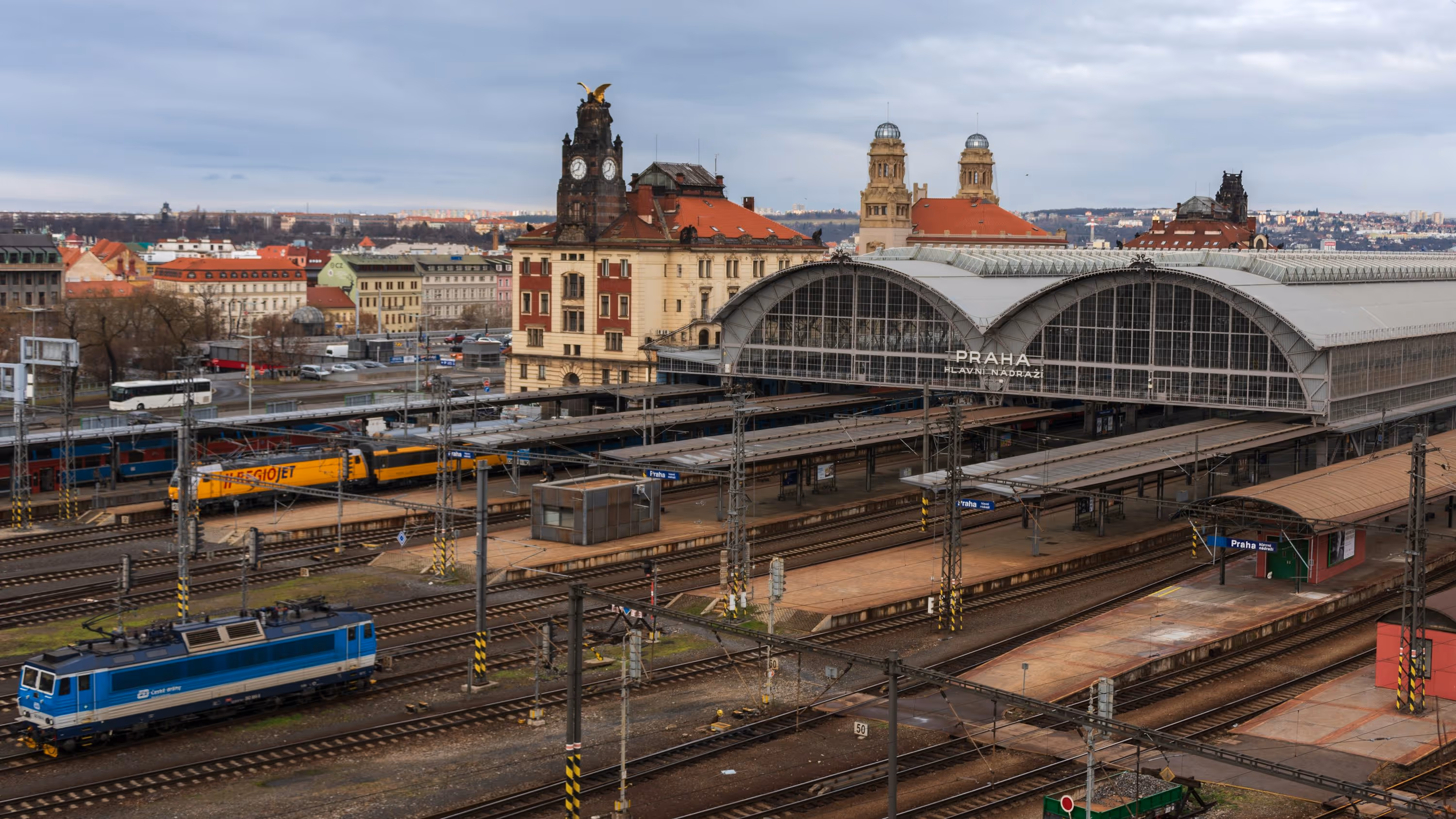 a train station with several trains on the tracks