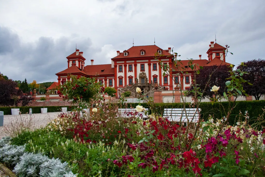 Troja Chateau with terraced gardens and decorative vases.