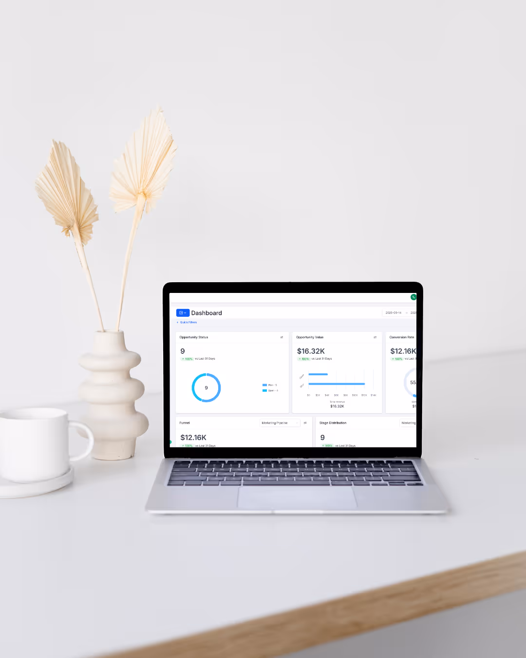 Open laptop displaying Mektra CRM dashboard on a clean, modern desk setup with neutral decor and a white background.
