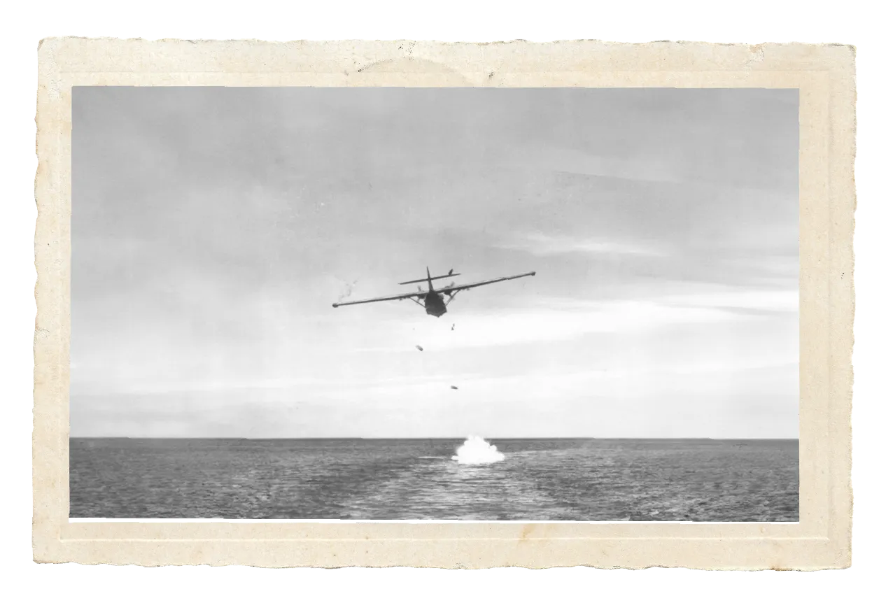 1943 PBY-5A Catalina dropping bombs over the ocean