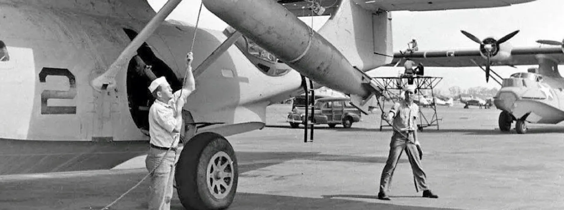 Soldiers loading a bomb onto a 1943 PBY-5A Catalina