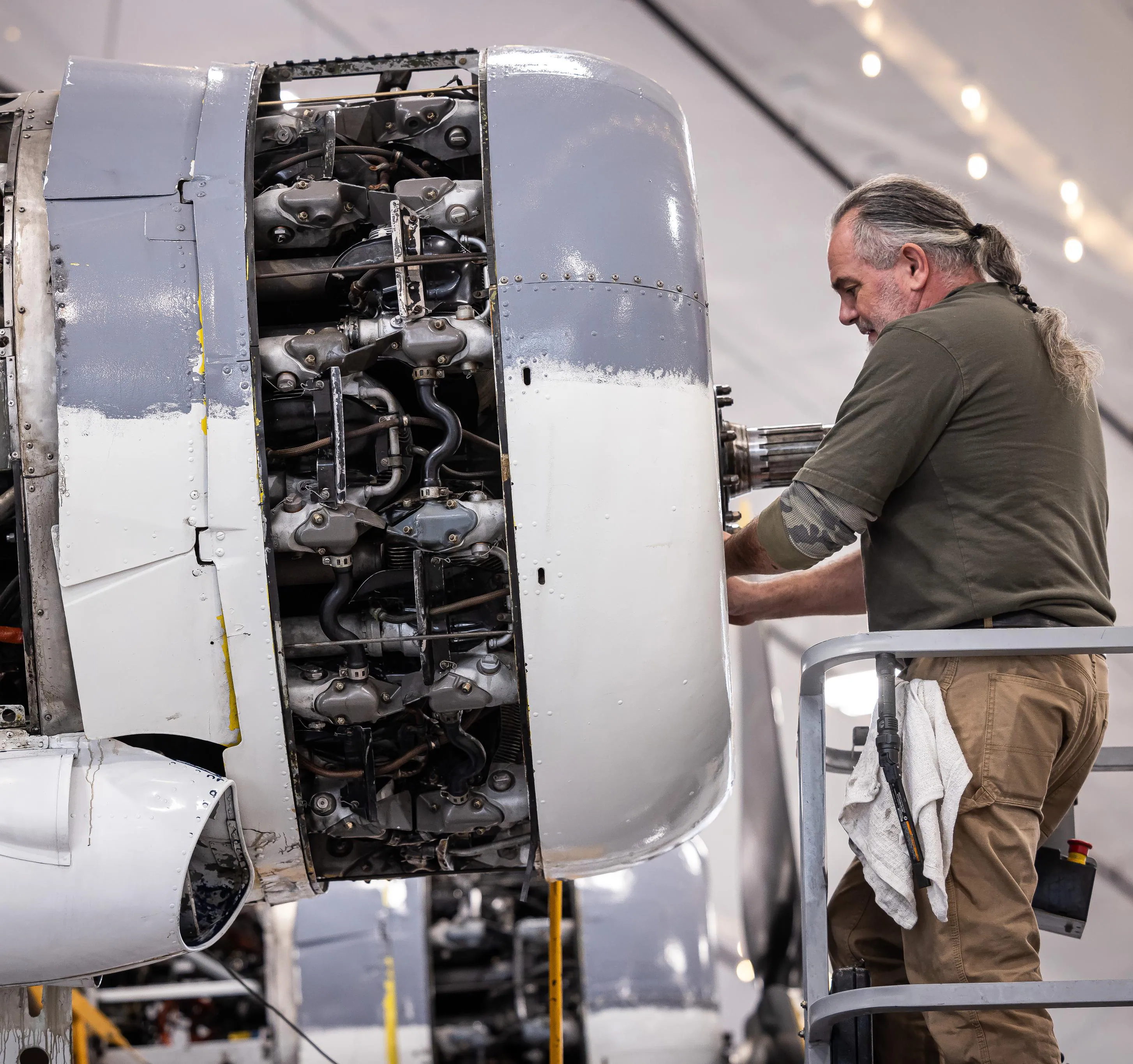 A mechanic working on Soaring by the Sea's 1943 PBY-5A Catalina