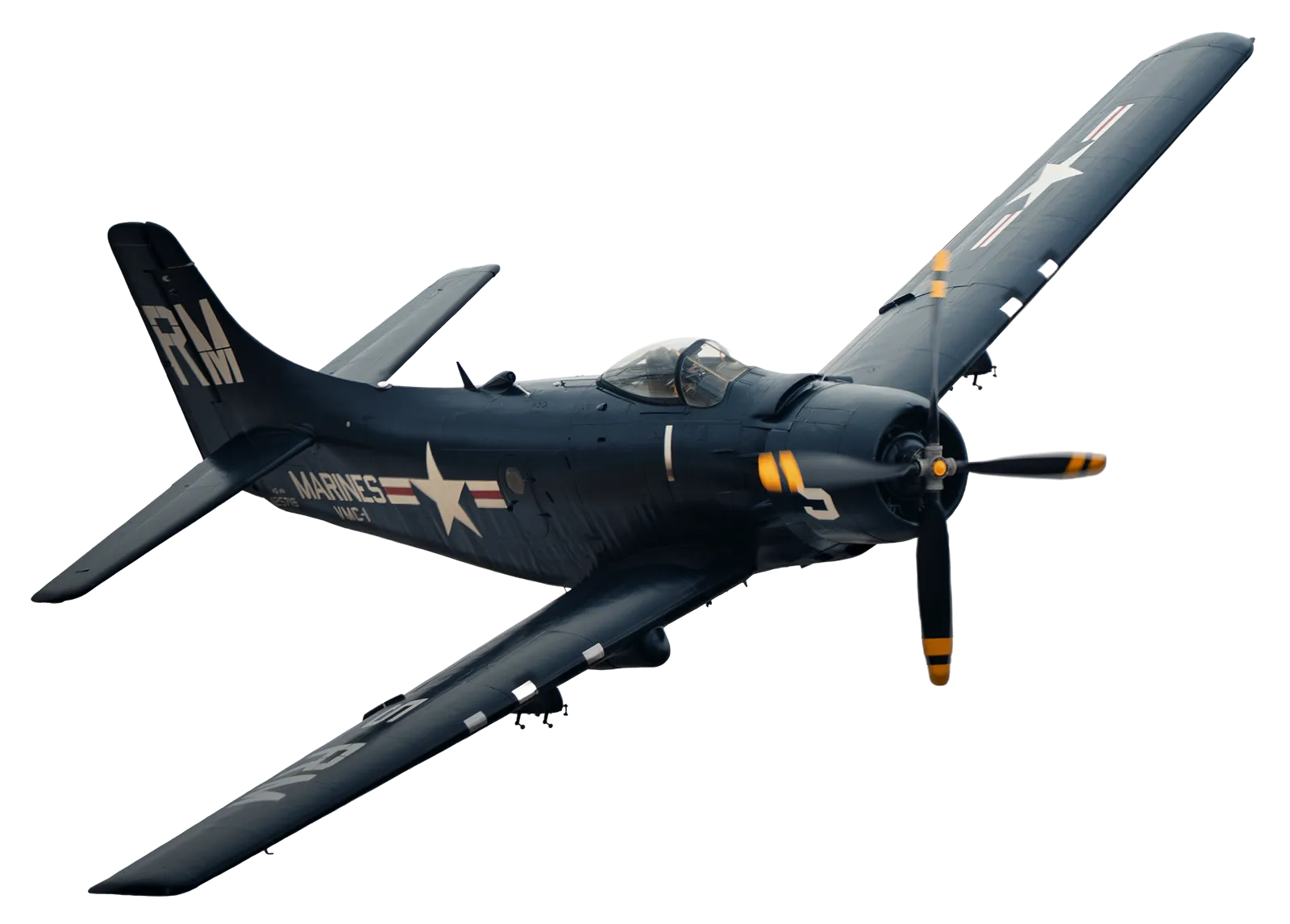 Blue vintage US Marines propeller airplane in flight with wings tilted upward.