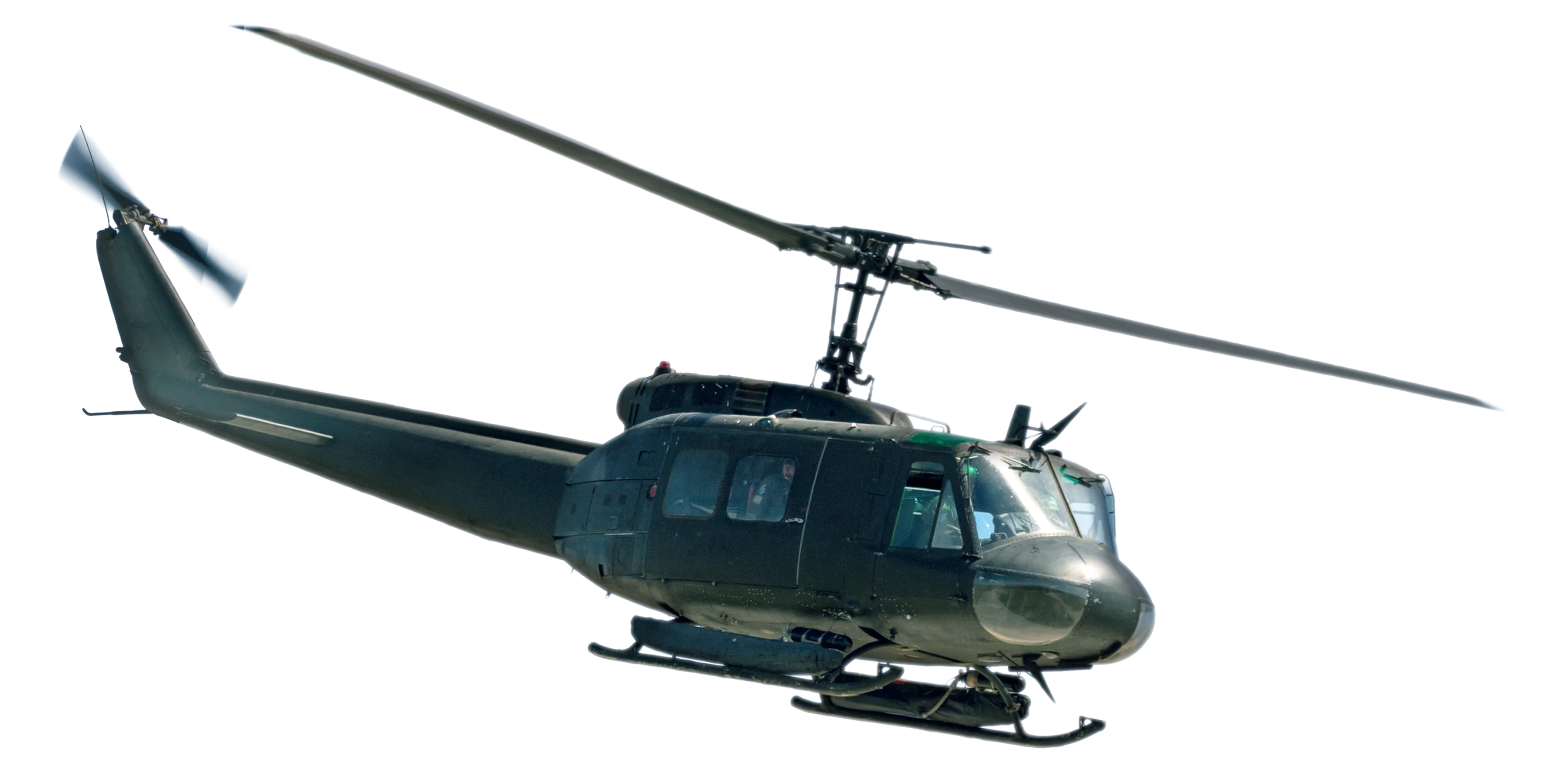 Black military helicopter flying with visible windows and rotor blades.