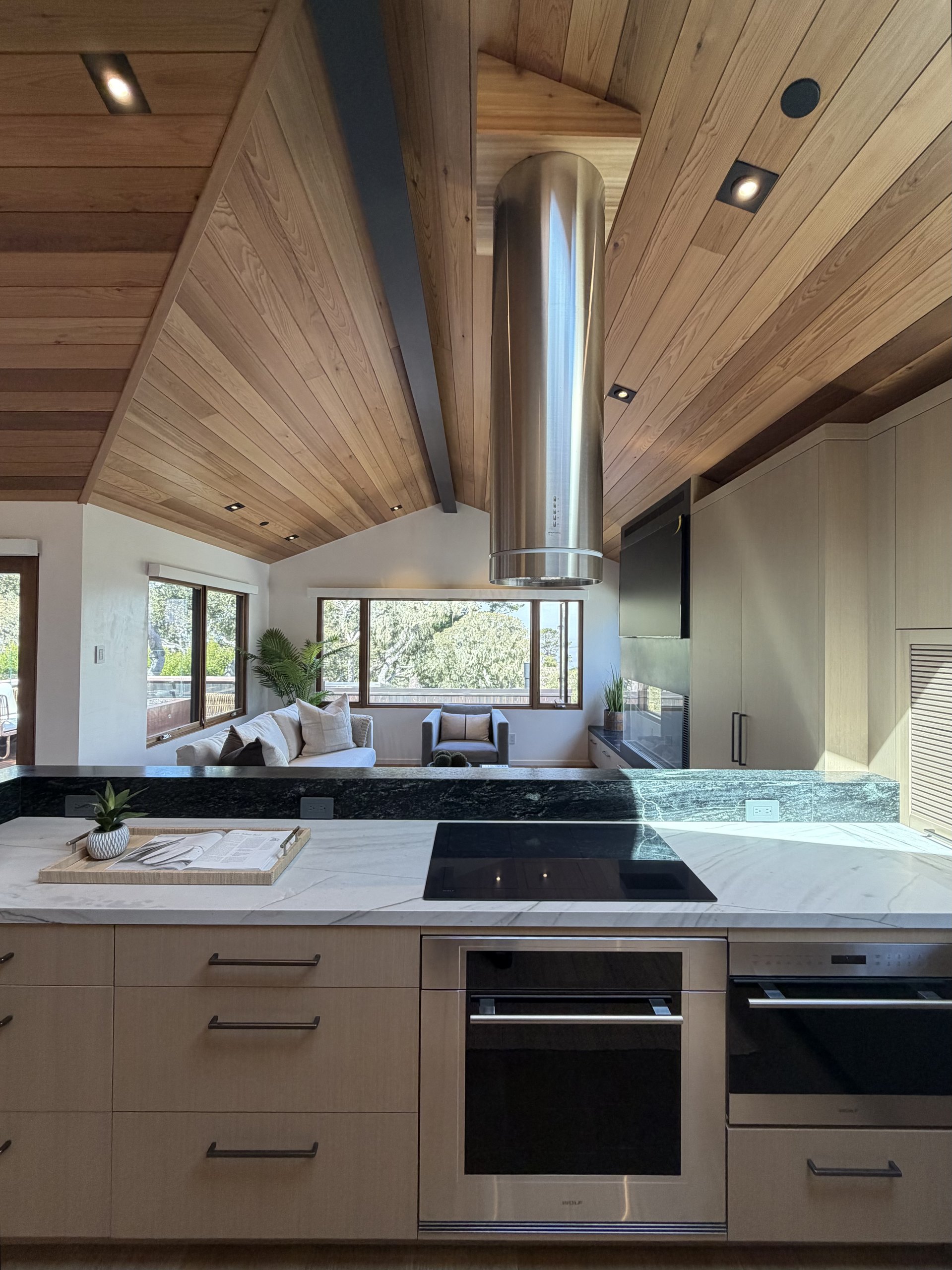 Brisa kitchen with quartzite counters, Wolf ovens, and the living room beyond