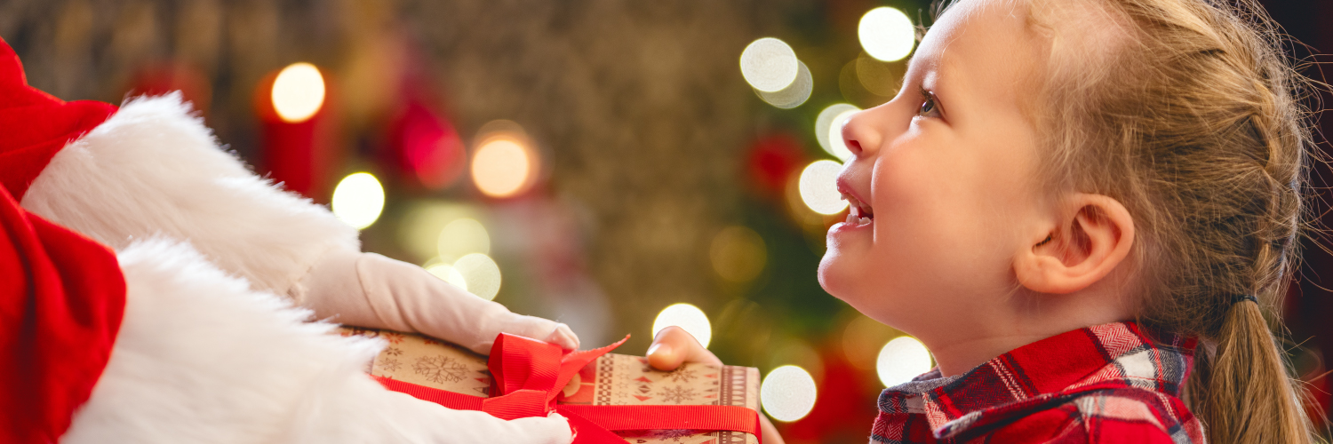 Santa giving child a present.