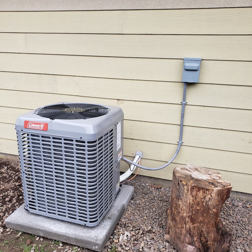 Outdoor air conditioning unit after a professional air conditioner installation beside a residential home