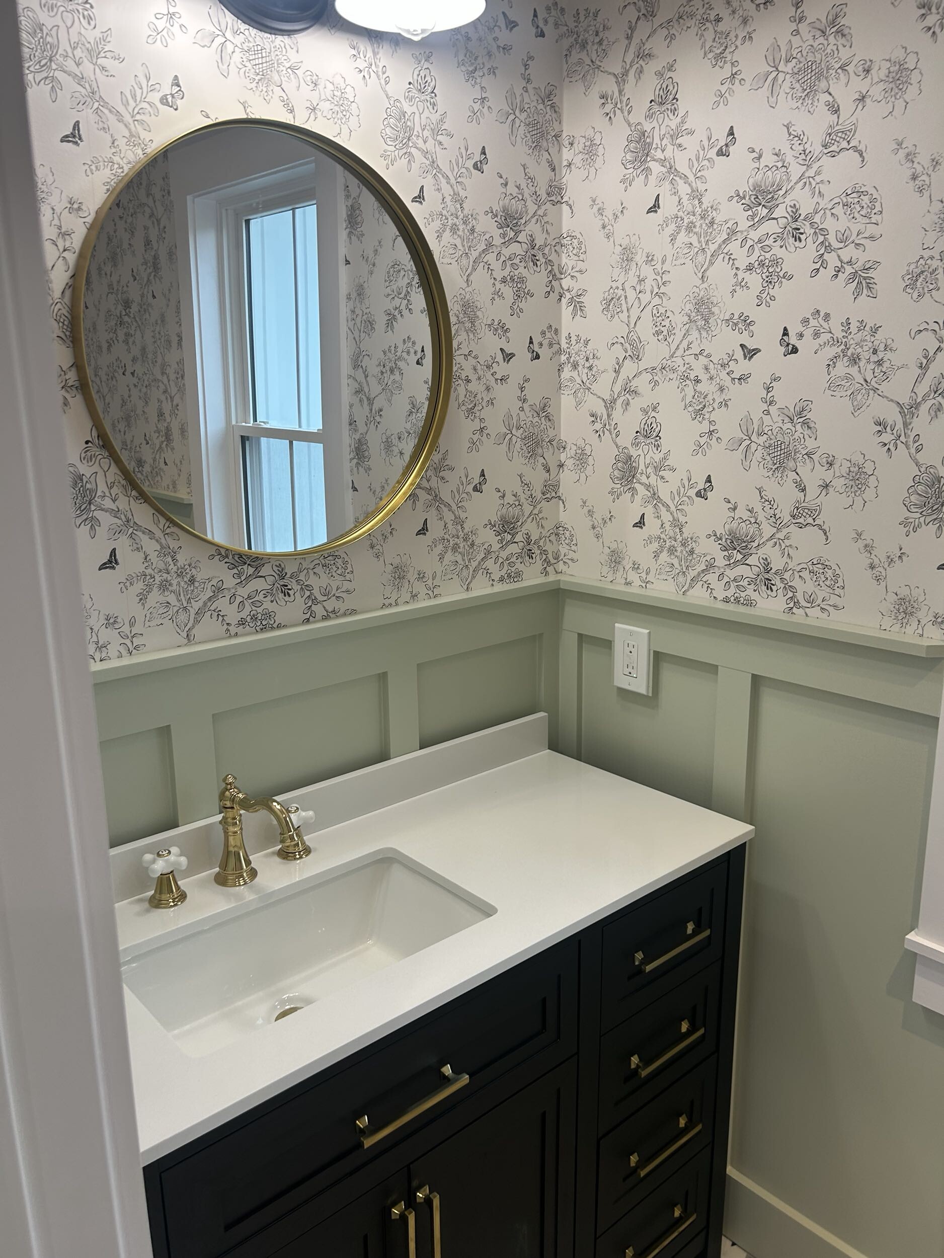 Bathroom vanity with patterned wallpaper