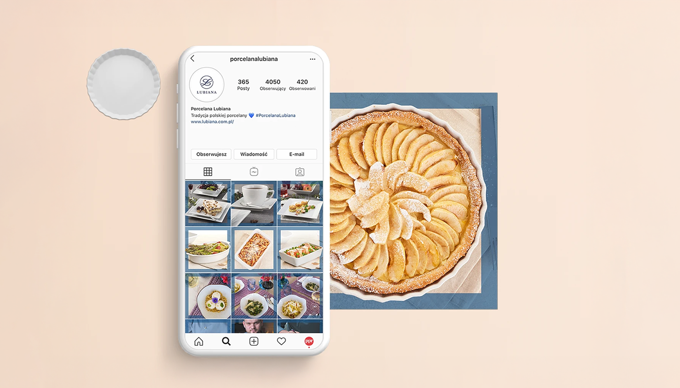 Smartphone showing Porcelana Lubiana Instagram profile with a grid of food photos, next to a white porcelain tart dish holding a sliced apple tart dusted with powdered sugar.