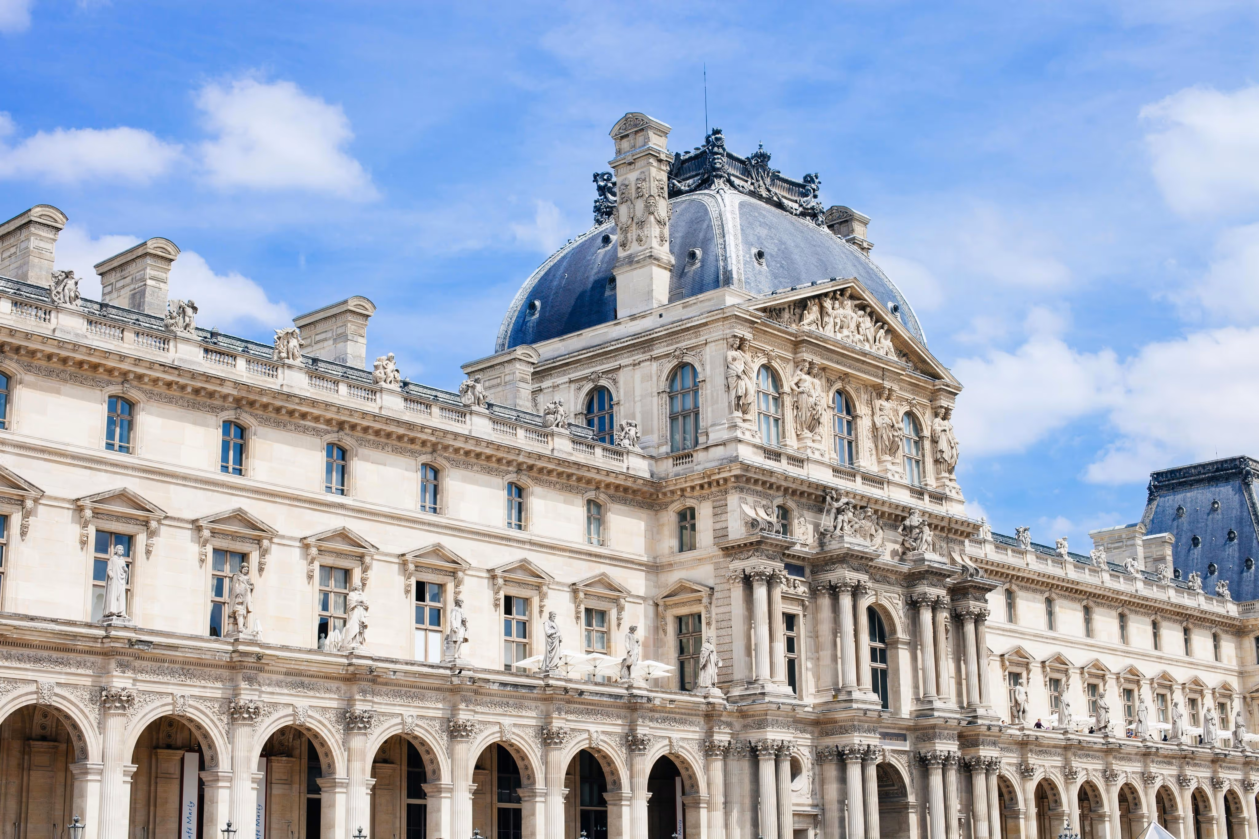 A large white building with a blue sky in the background.