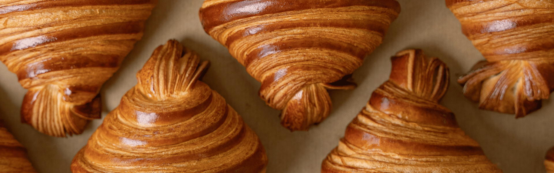 Many croissants placed on a tray