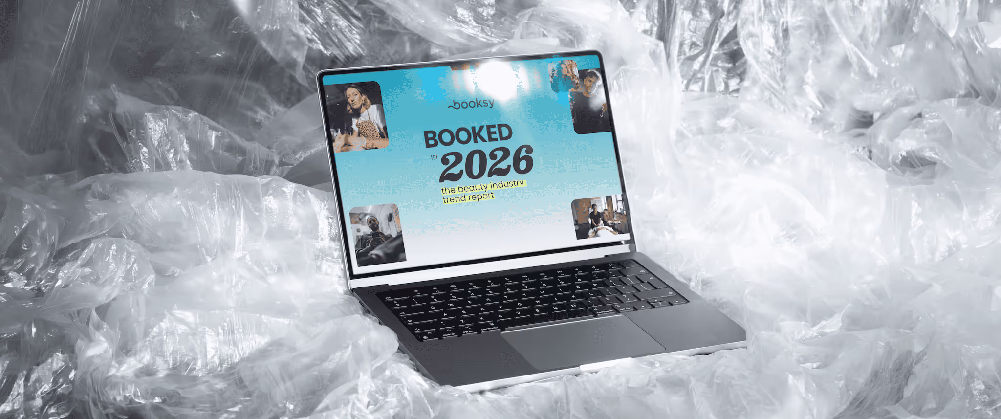 Laptop on clear plastic wrap displaying Booksy's 2026 beauty industry trend report titled BOOKED.