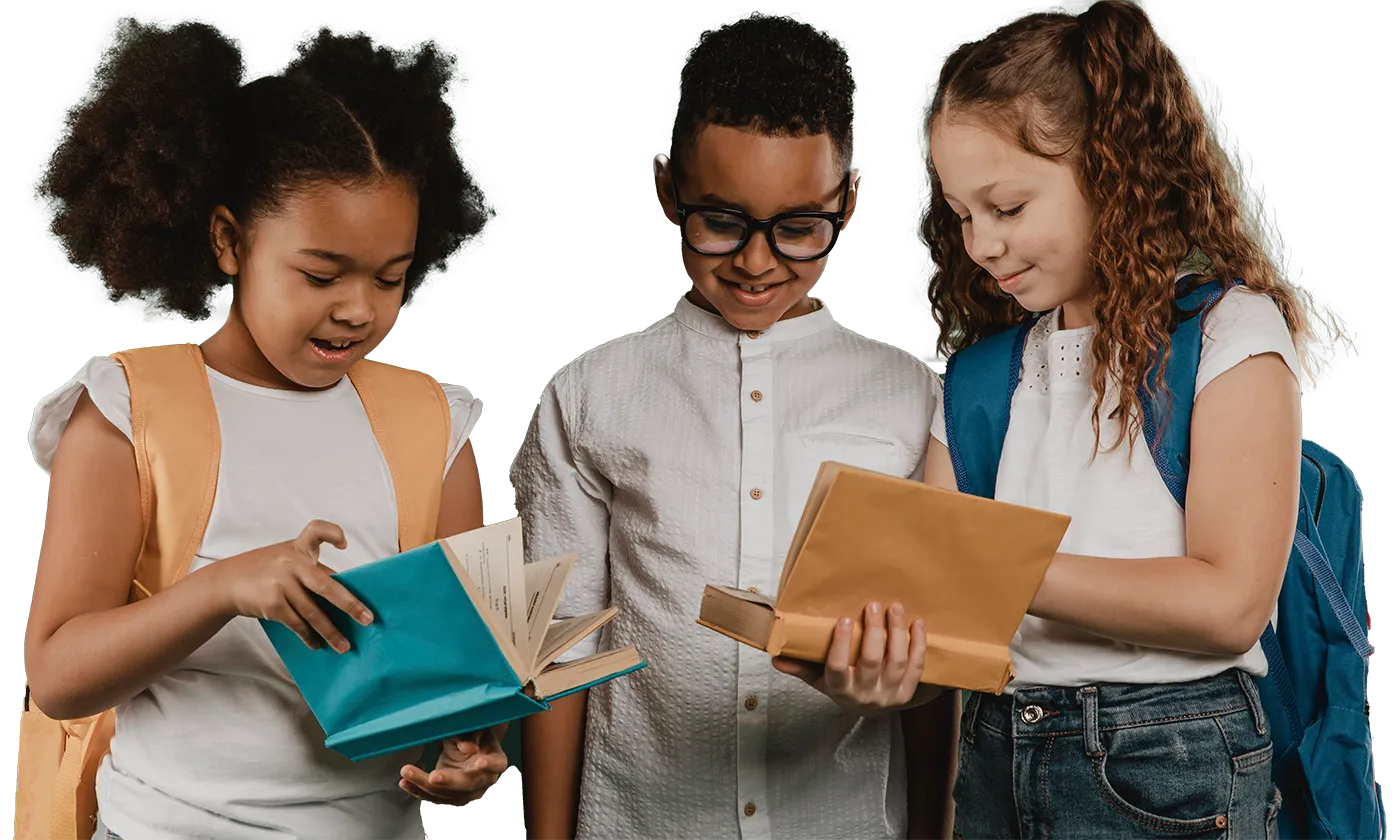 Three children looking at a book together.