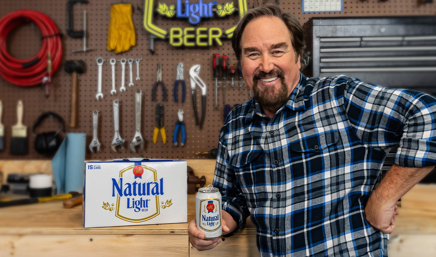 Man holding a Natural Light in garage
