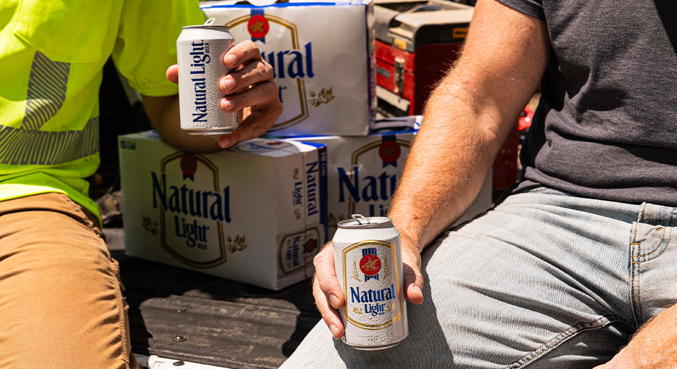 Guys holding Natural Lights in hand