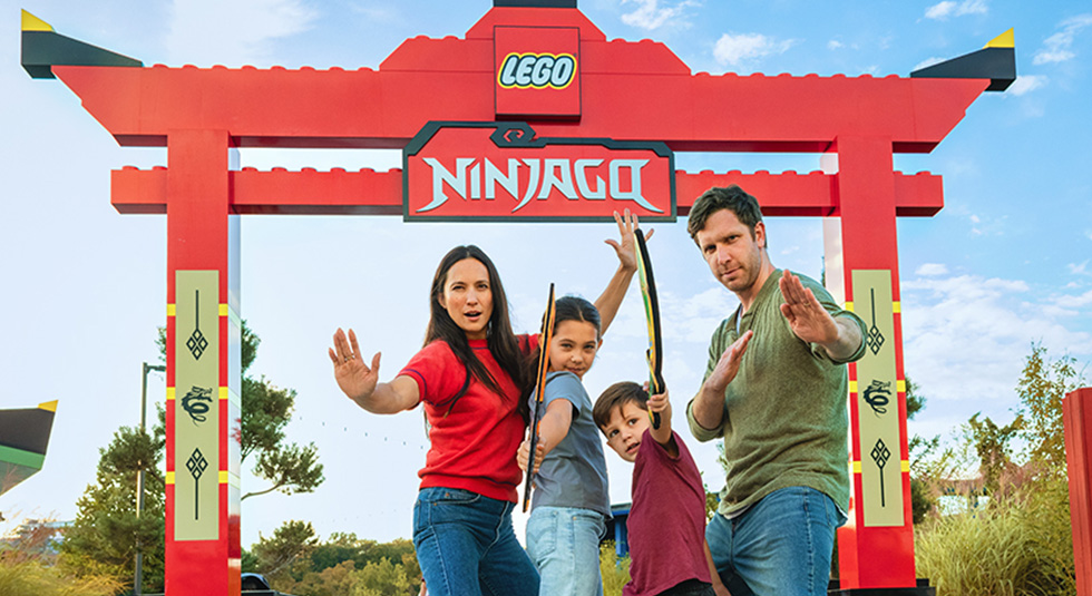 Family posing in front of Lego Ninjago